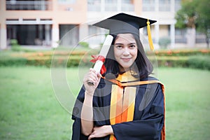 Female university graduates celebrate graduation with happiness after receive degree certificate in commencement ceremony. Asian