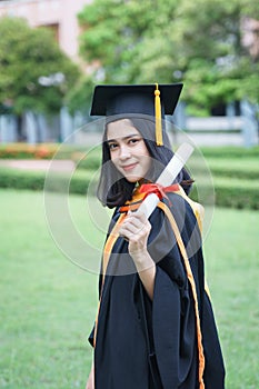 Female university graduates celebrate graduation with happiness after receive degree certificate in commencement ceremony. Asian