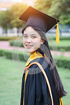 Female university graduates celebrate graduation with happiness after receive degree certificate in commencement ceremony. Asian