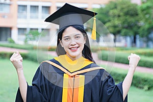 Female university graduates celebrate graduation with happiness after receive degree certificate in commencement ceremony. Asian