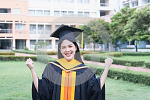 Female university graduates celebrate graduation with happiness after receive degree certificate in commencement ceremony. Asian