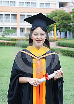 Female university graduates celebrate graduation with happiness after receive degree certificate in commencement ceremony. Asian