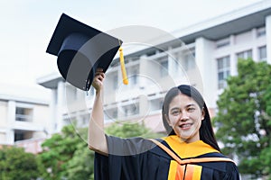 Female university graduates celebrate graduation with happiness after receive degree certificate in commencement ceremony. Asian