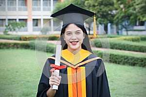 Female university graduates celebrate graduation with happiness after receive degree certificate in commencement ceremony. Asian