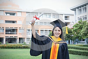 Female university graduates celebrate graduation with happiness after receive degree certificate in commencement ceremony. Asian