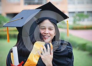 Female university graduates celebrate graduation with happiness after receive degree certificate in commencement ceremony. Asian