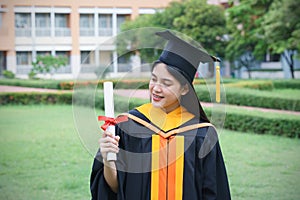 Female university graduates celebrate graduation with happiness after receive degree certificate in commencement ceremony. Asian