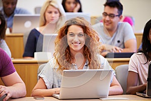 Female University Student Using Laptop In Lecture