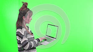 Female using laptop computers. Young woman on green screen background