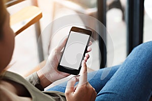 female using phone show white screen display in coffee shop outdoor lifestyle