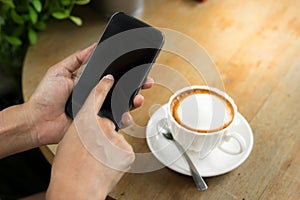 Female using smart phone and drink coffee