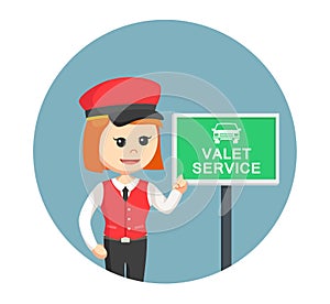 Female valet services standing with valet service sign