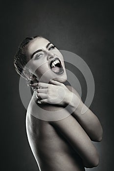 Female vampire showing fangs photo