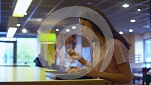 Female vegetarian eating fresh salad in restaurant, sitting table, healthy meal