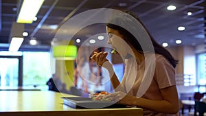 Female vegetarian eating fresh salad in restaurant, sitting table, healthy meal