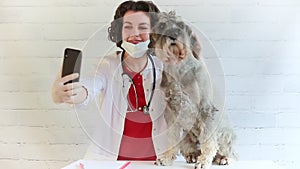 A female veterinarian after examining a dog is photographed in her office