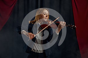 Female violonist with bow and violin, solo concert