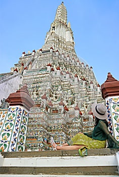 Female Visitor Being Impressed by Phraprang, the Central Spire of Wat Arun, Bangkok, Thailand