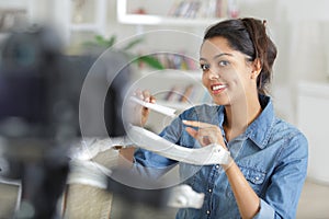 female vlogger looking at camera during recording episode