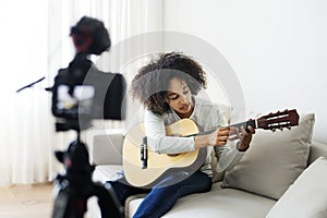 Female vlogger recording music related broadcast at home photo