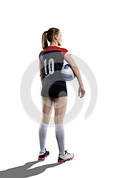 Female volleyball player standing with ball