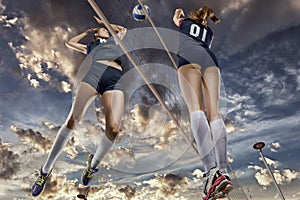 Female volleyball players jumping close-up