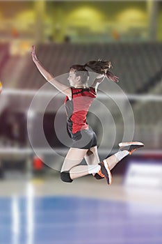 Female volleyball players jumping close-up on vollayball court.