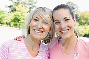 Female volunteers participating in breast cancer awareness