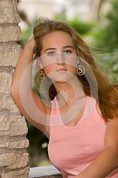 Female Waist-up Portrait Leaning Against Rock Pillar