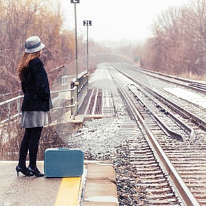Female Waiting for a Train during Winter Snow Station