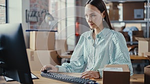 Female Warehouse Inventory Manager Using Desktop Computer, Preparing Cardboard Box Order for