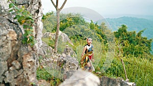 a female warrior in a golden dress and crown walks in a forest with a tired and haggard face