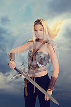 Female warrior with sword and hair blowing in wind