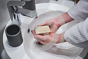 Female washing her hands with natural soap