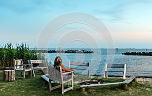 Female watching a sunset on a Chesapeake Bay beach