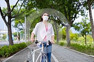 Female wearing mask with bicycle