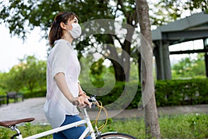 Female wearing mask with bicycle