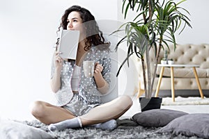 Female wearing pajamas reading at home