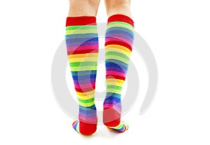 Female wearing rainbow colored socks from the back