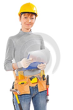 Female wearing working clothes and construction tools holding cl