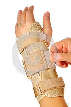 Female wearing wrist brace over white background