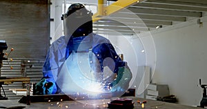 Female welder using blow torch on a rod 4k