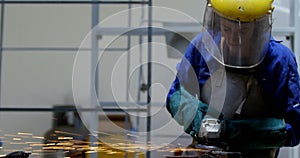 Female welder using grinder in workshop 4k