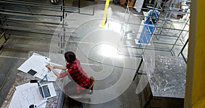 Female welder working at desk 4k
