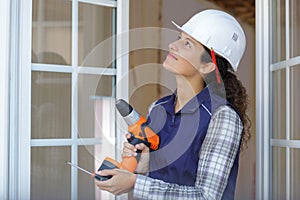 female window builder working on mount new installation