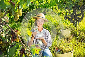 Female winemaker inviting to tasting wine in vineyard