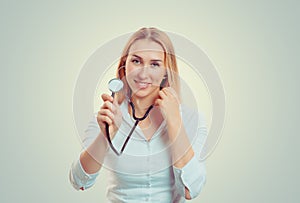 A female woman doctor with a stethoscope listening looking at you