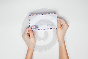 A female(woman) hand hold a envelope isolated