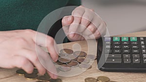 female woman hands calculating counting money coins euro cents on wooden table