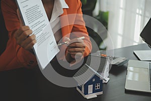 Female woman hands holding home model, small miniature white toy house. Mortgage property insurance dream moving home and real